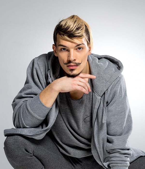 young athletic male dancer in sportswear posing wh 2M27V4Z